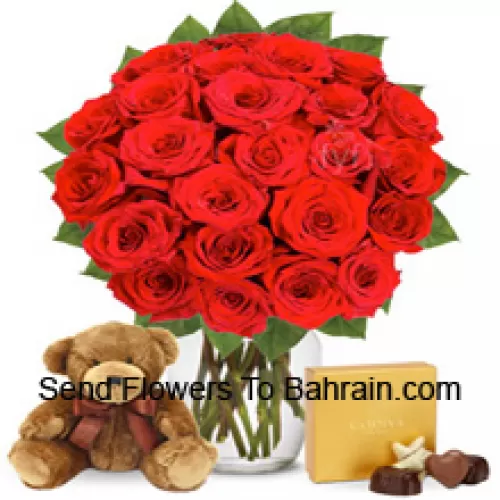24 Red Roses With Some Ferns In A Glass Vase Accompanied With An Imported Box Of Chocolates And A Cute 12 Inches Tall Brown Teddy Bear